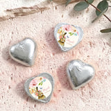 Silver foil-covered chocolate hearts with floral wrapped center medallions