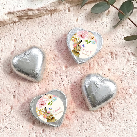 Silver foil-covered chocolate hearts with floral wrapped center medallions
