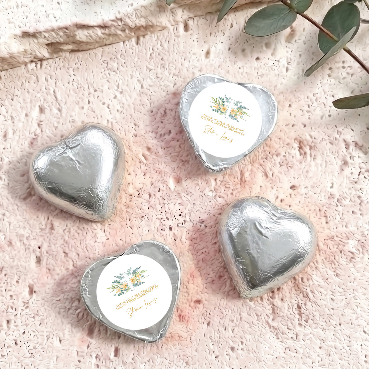 Silver foil-covered chocolate hearts with printed personalised label, glossy heart shapes