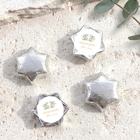 Personalised foil-covered chocolate stars, silver with cross label on white circle
