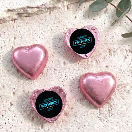 Foil-covered chocolate hearts, pink, with “Happy Father’s Day” label on top.
