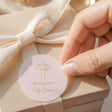 Pink round cross confirmation label with dove icon and “Ruby Brown” name