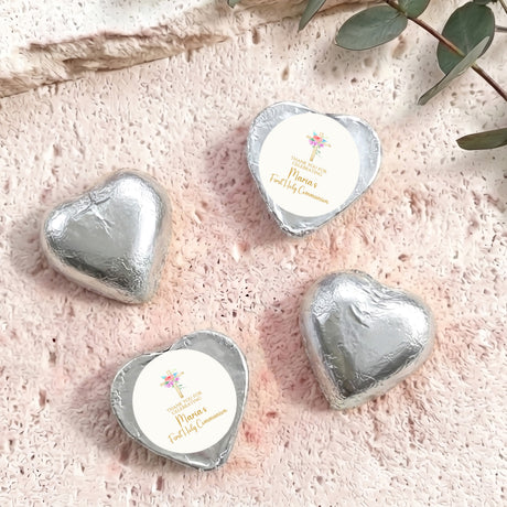 Silver heart-shaped foil-covered chocolate with personalized First Holy Communion message.