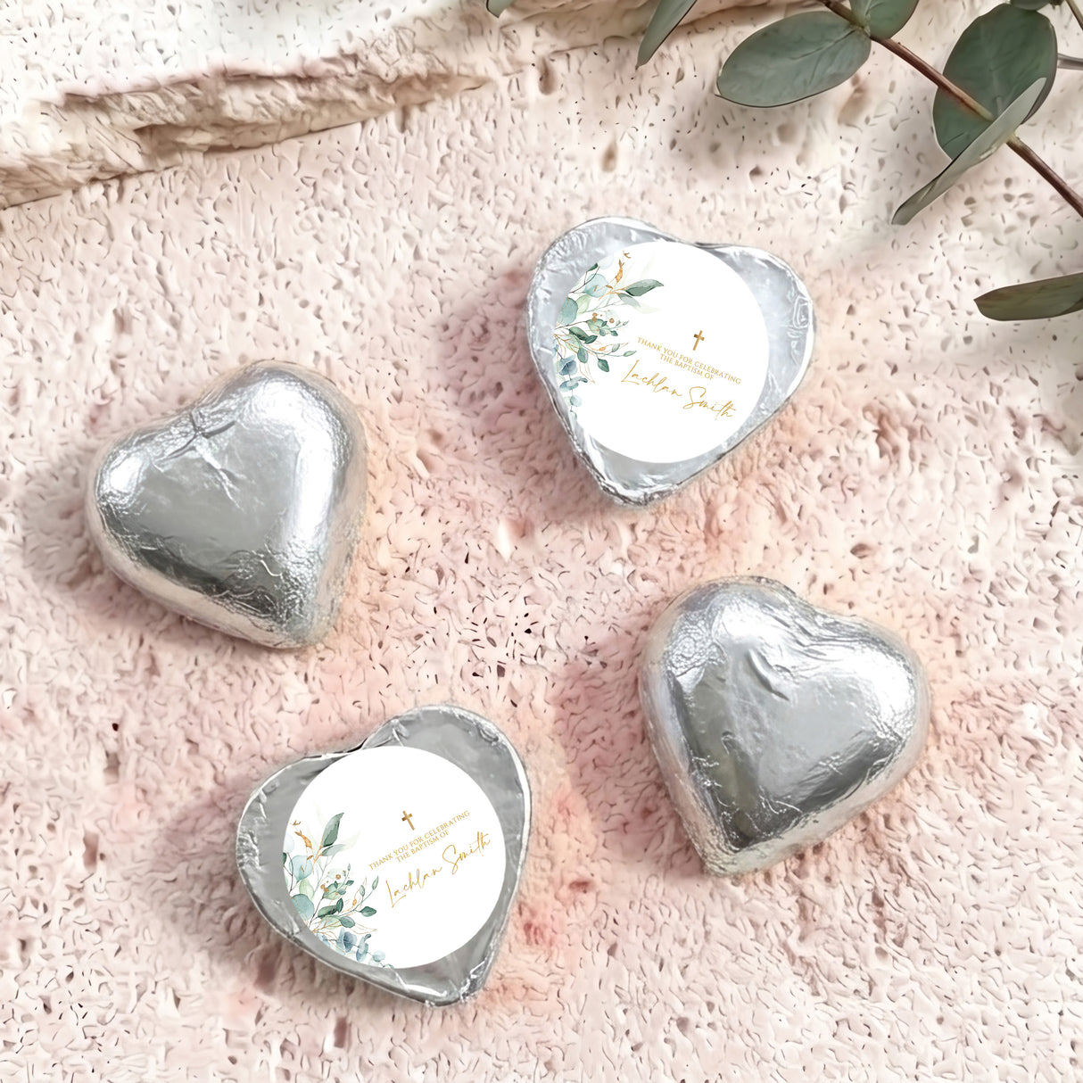 Silver foil heart chocolates with baptism cross and floral label on white center
