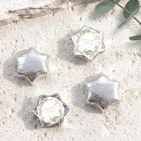 Silver foil star chocolates with personalised 'One' label, dinosaur theme