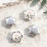 Silver foil-covered star chocolates with round "A Wild One" label