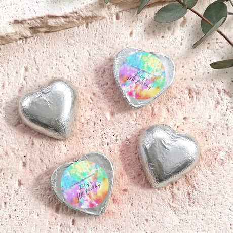 Silver foil covered heart chocolates with colorful printed center