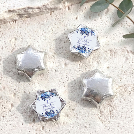 Silver foil-wrapped chocolate stars with printed floral confirmation label, four pieces.