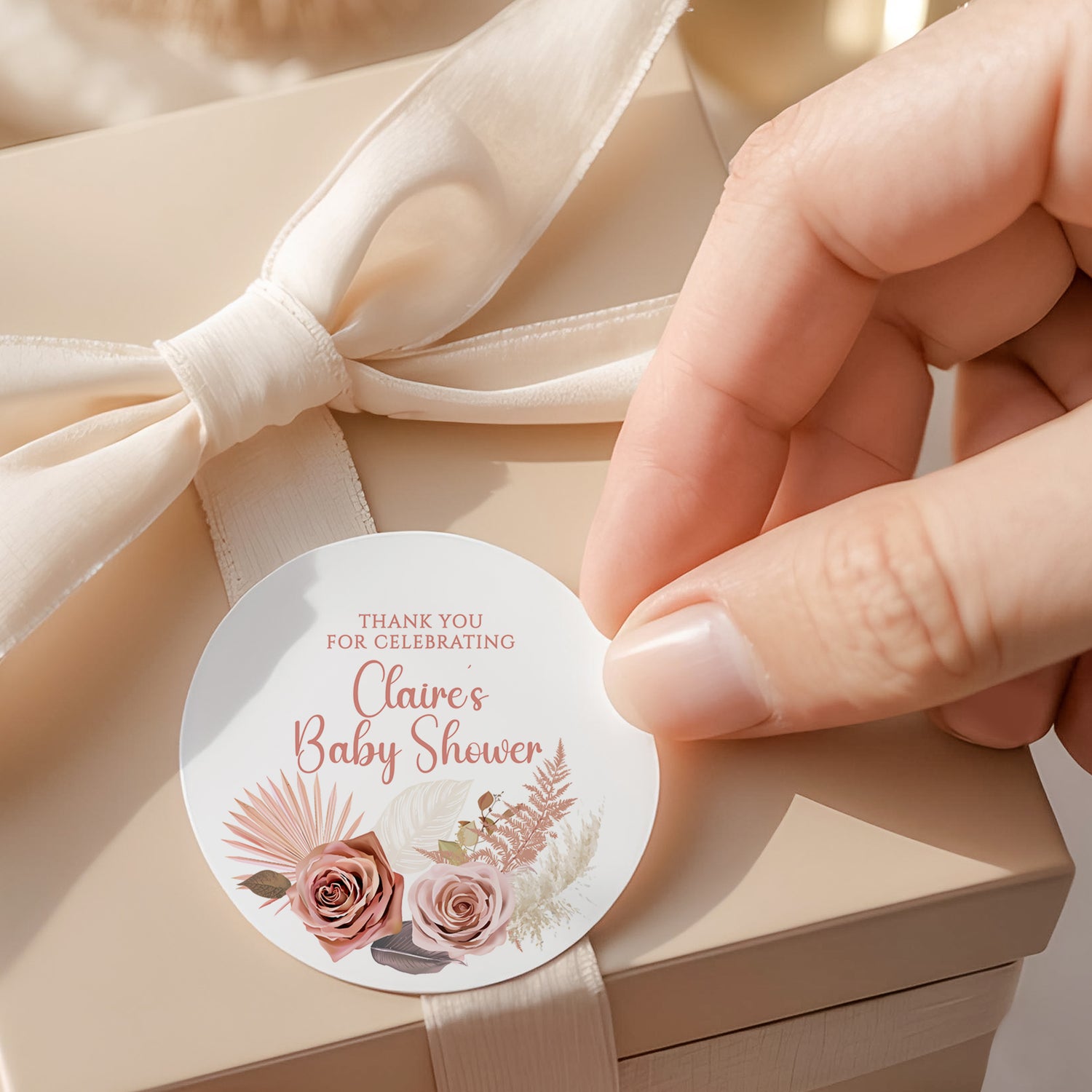 Round thank-you baby shower label with pink floral and roses; reads 'Claire's Baby Shower'.