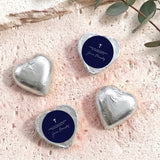 Foil-covered chocolate hearts, silver metallic with navy label and cross