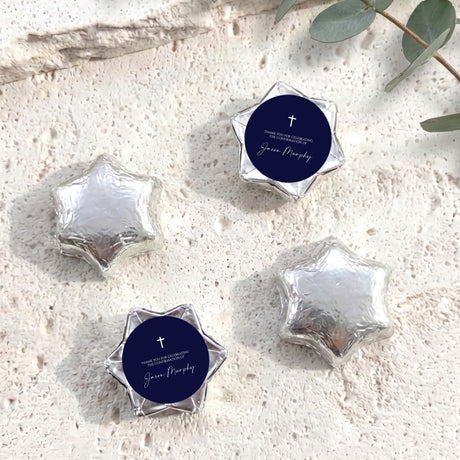 Silver foil star chocolates with dark blue round label featuring cross and message