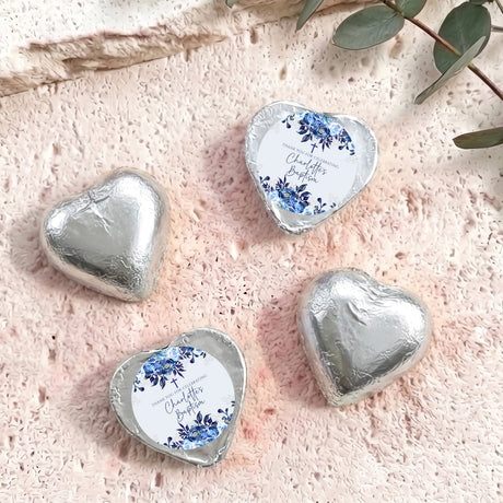 Silver foil-covered chocolate hearts with floral christening label