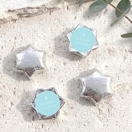 Silver foil-covered chocolate stars with cross medallion labels