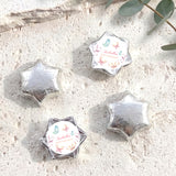 Silver foil-covered chocolate stars with a round personalised label on one star