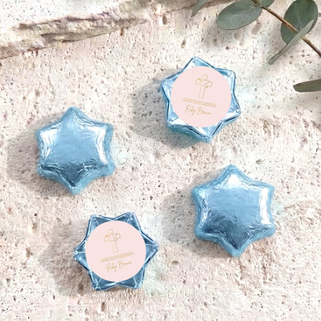 Blue foil chocolate stars with round personalised label and small cross emblem