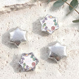 Silver foil star balloons plus white dinosaur “Dolly is Four” foil balloon