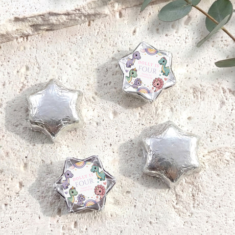 Silver foil star balloons plus white dinosaur “Dolly is Four” foil balloon
