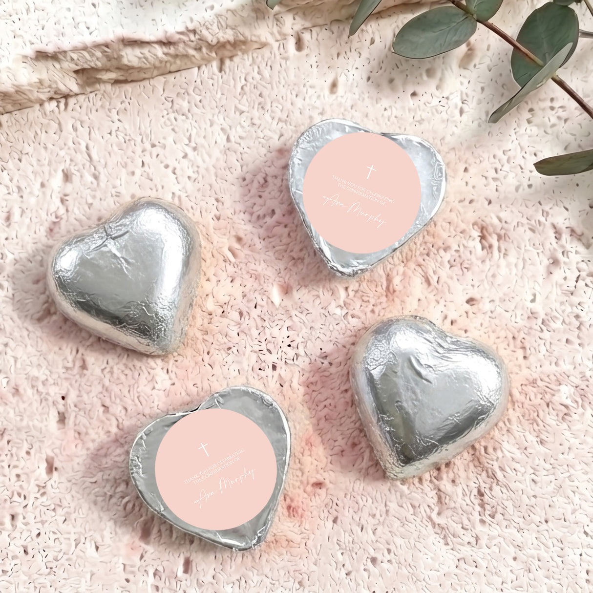 Foil-covered chocolate hearts in silver foil with cross and personal message
