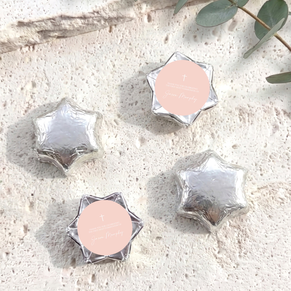Star-shaped foil chocolates in silver, with pale center and cross design