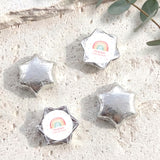 Foil-covered chocolate stars in silver with white center label.