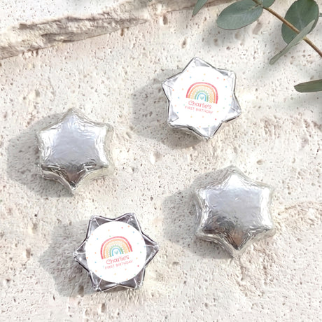 Silver foil-covered chocolate star sweets with “Charlie's First Birthday” label