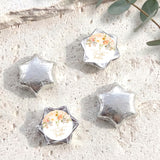 Foil-covered chocolate stars in silver tones with a floral personalisation label