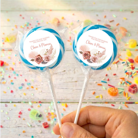 Blue floral boho personalised lollipops with “Claire & Marcus” on round white labels