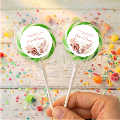 Green floral boho personalised lollipops with “Claire & Marcus” on round white labels