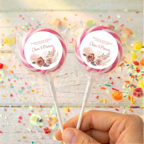 Pink floral boho personalised lollipops with “Claire & Marcus” on white labels