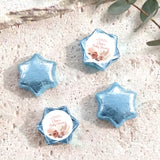 Blue foil-covered chocolate stars with round 'Baby Shower' label