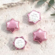 Pink foil-covered chocolate stars for Mother’s Day, with “Happy Mother’s Day” floral center