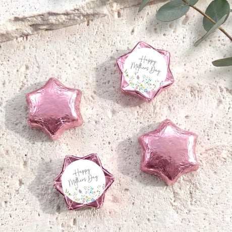 Pink foil-covered chocolate stars for Mother’s Day, with “Happy Mother’s Day” floral center