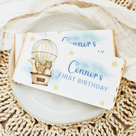 First birthday chocolate bar wrapper with animals in a hot air balloon, blue text