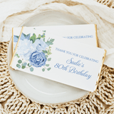 Baby blue floral birthday chocolate bar wrapper with 'Sadie's 80th Birthday' thank-you card text.