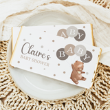 Baby shower chocolate bar wrapper with Claire's name, bear, balloons, and polka dots