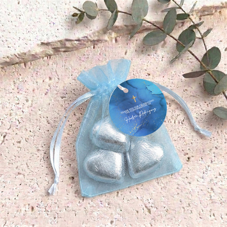 Personalised organza confirmation bag with light blue foil heart chocolates and blue name tag