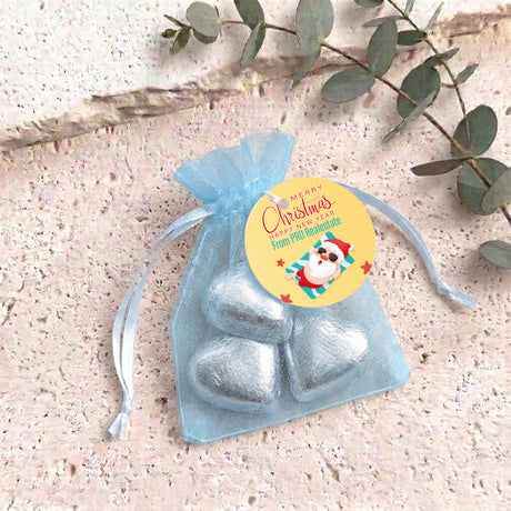 Light blue metallic heart chocolates in sheer white organza gift bag with drawstring