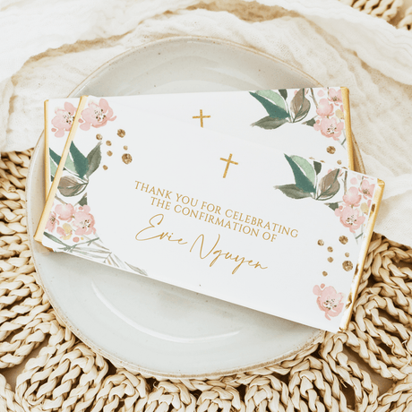 Confirmation chocolate bar card with blush flowers, green leaves, and gold cross accents