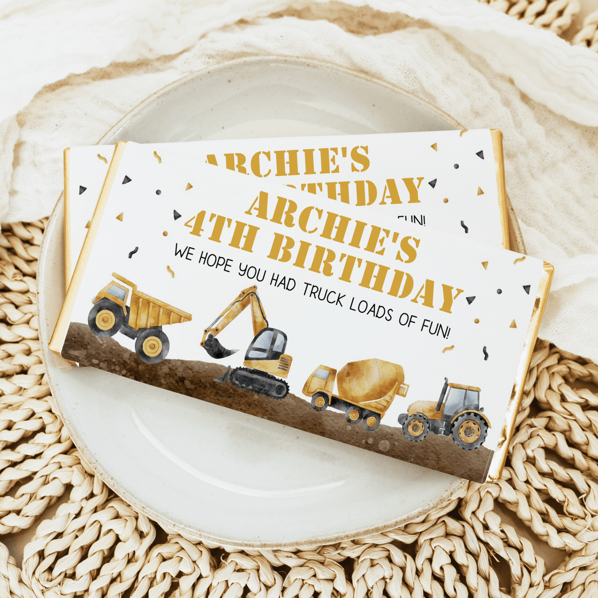 Construction birthday chocolate bar wrapper with trucks, excavator, and 'Archie's' text
