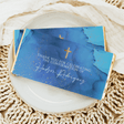 Blue chocolate bar wrapper with gold marble, thank-you text, and gold cross icons
