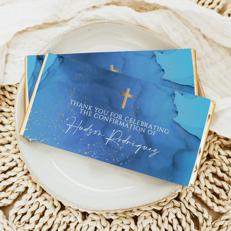 Blue chocolate bar wrapper with gold marble, thank-you text, and gold cross icons