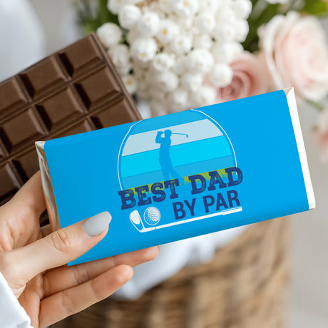 Blue chocolate bar wrapper held in hand with 'Best Dad By Par' golfer graphic