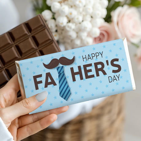 Chocolate bar wrapper held in hand with blue tie and moustache, “Happy Father’s Day”