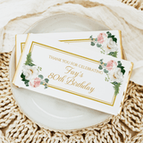 Birthday chocolate bar with white wrapper, floral border, and gold “Fay’s 80th Birthday” text