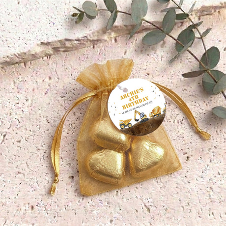 Gold organza gift bag with personalized round label and chocolate truck hearts