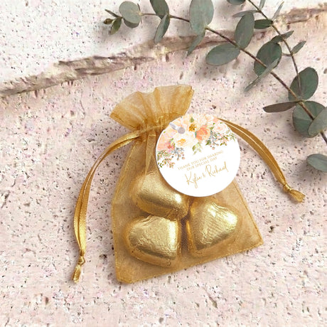 Gold organza gift bag with gold metallic heart and round personalised chocolate label