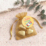 Gold metallic heart chocolates in sheer gold organza gift bag with drawstring