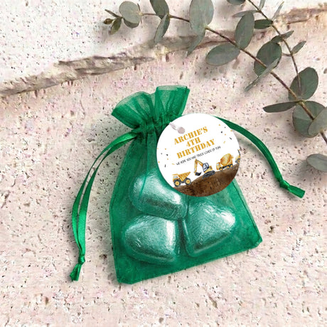 Green organza gift bag with personalized round label and chocolate truck hearts
