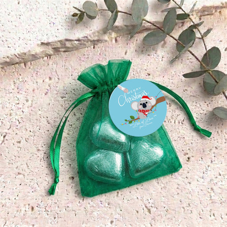 Green heart chocolates in sheer green organza drawstring gift bag with round label
