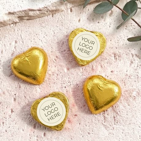 Gold foil-covered chocolate hearts with “YOUR LOGO HERE” label